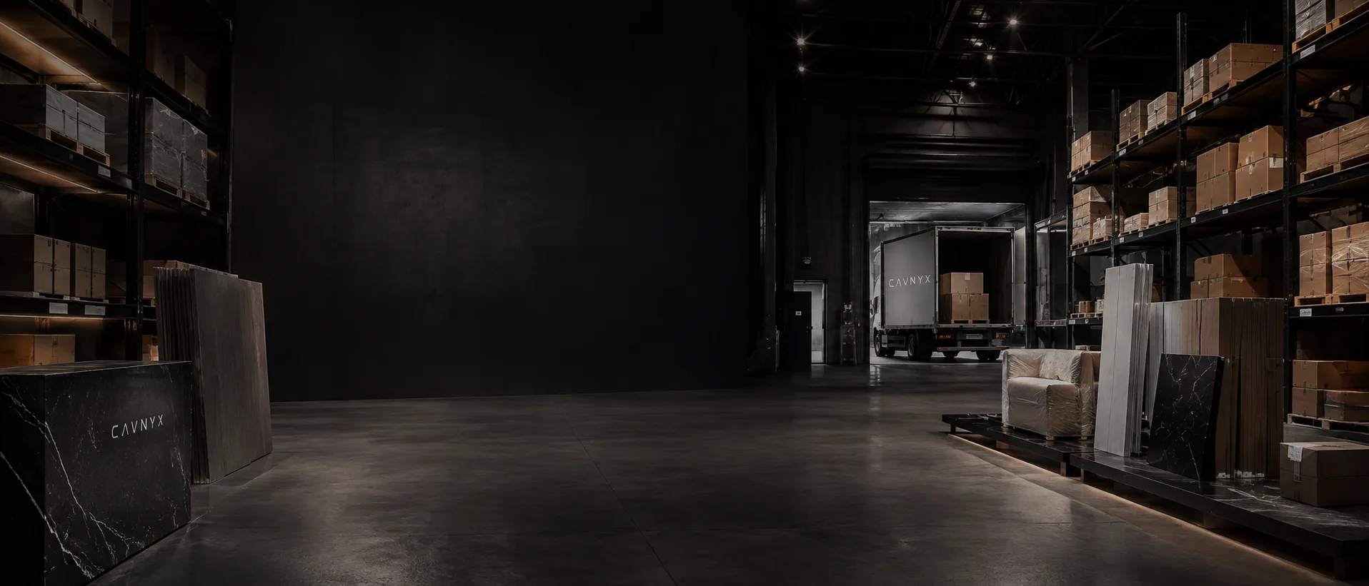 CAVNYX Phoenix warehouse aisle with loaded delivery truck at the dock and branded stone samples